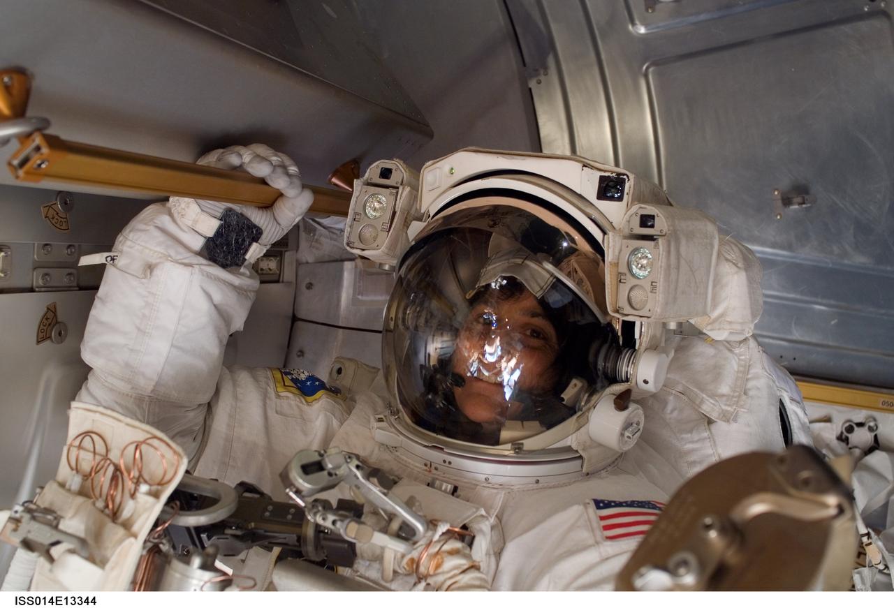 ISS014-E-13344 (4 Feb. 2007) --- Astronaut Sunita L. Williams, Expedition 14 flight engineer, participates in the second of three sessions of extravehicular activity (EVA) in nine days, as construction continues on the International Space Station. During the spacewalk, Williams and Michael E. Lopez-Alegria (out of frame), commander and NASA space station science officer, reconfigured the second of two cooling loops for the Destiny laboratory module, secured the aft radiator of the P6 truss after retraction and prepared the obsolete Early Ammonia Servicer (EAS) for removal this summer.