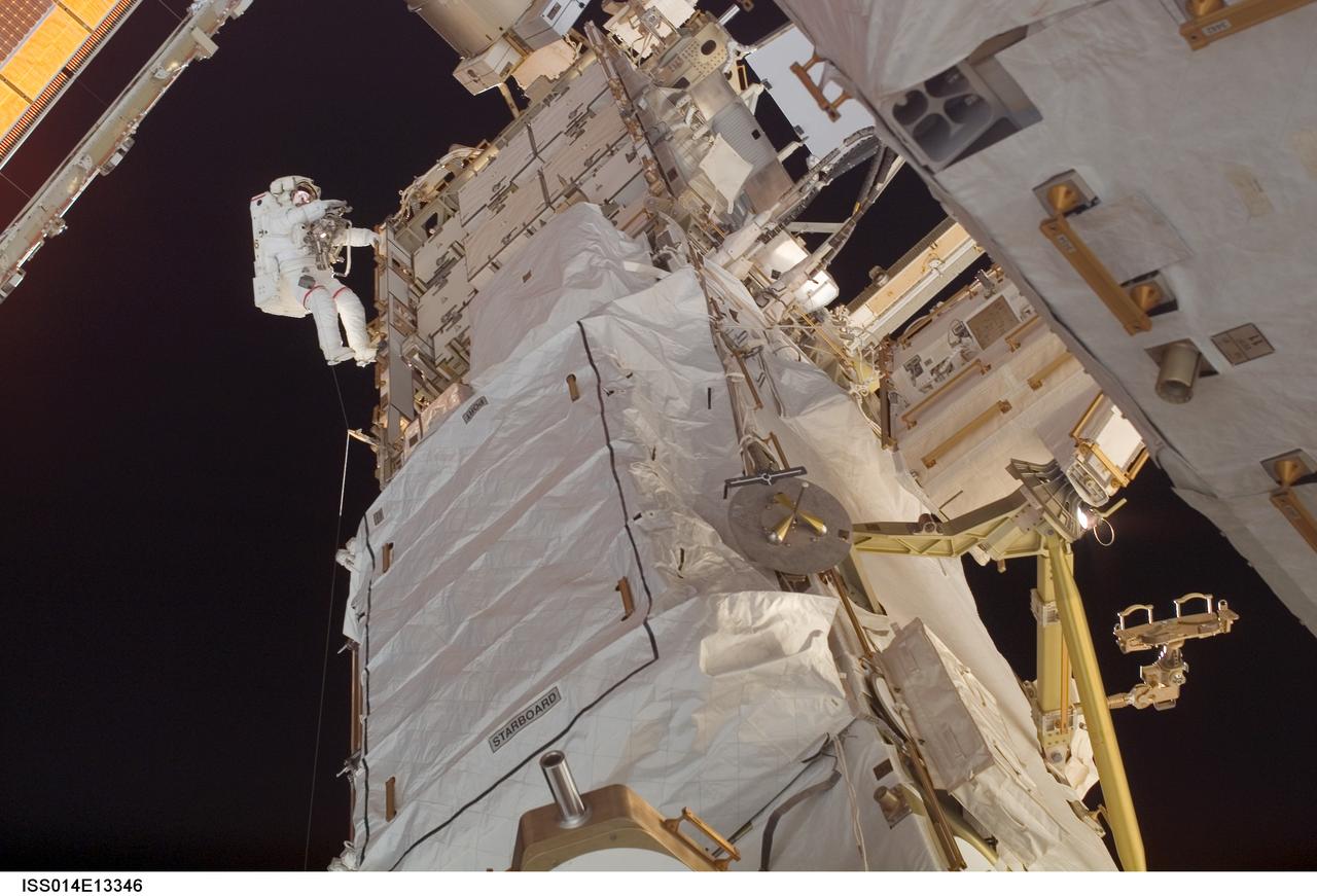 ISS014-E-13346 (4 Feb. 2007) --- Astronaut Michael E. Lopez-Alegria, Expedition 14 commander and NASA space station science officer, participates in the second of three sessions of extravehicular activity (EVA) in nine days, as construction continues on the International Space Station. During the spacewalk, Lopez-Alegria and Sunita L. Williams (out of frame), flight engineer, reconfigured the second of two cooling loops for the Destiny laboratory module, secured the aft radiator of the P6 truss after retraction and prepared the obsolete Early Ammonia Servicer (EAS) for removal this summer.