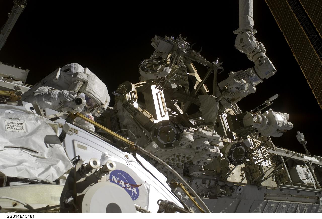 ISS014-E-13481 (8 Feb. 2007) --- Astronaut Sunita L. Williams, Expedition 14 flight engineer, uses a digital still camera during the final of three sessions of extravehicular activity (EVA) in nine days, as construction continues on the International Space Station. During the 6-hour, 40-minute spacewalk, Williams and Michael E. Lopez-Alegria (out of frame), commander and NASA space station science officer, completed tasks that will allow for the attachment of a cargo platform during the STS-118 mission this summer and relocation of the P6 truss during STS-120 later this year.