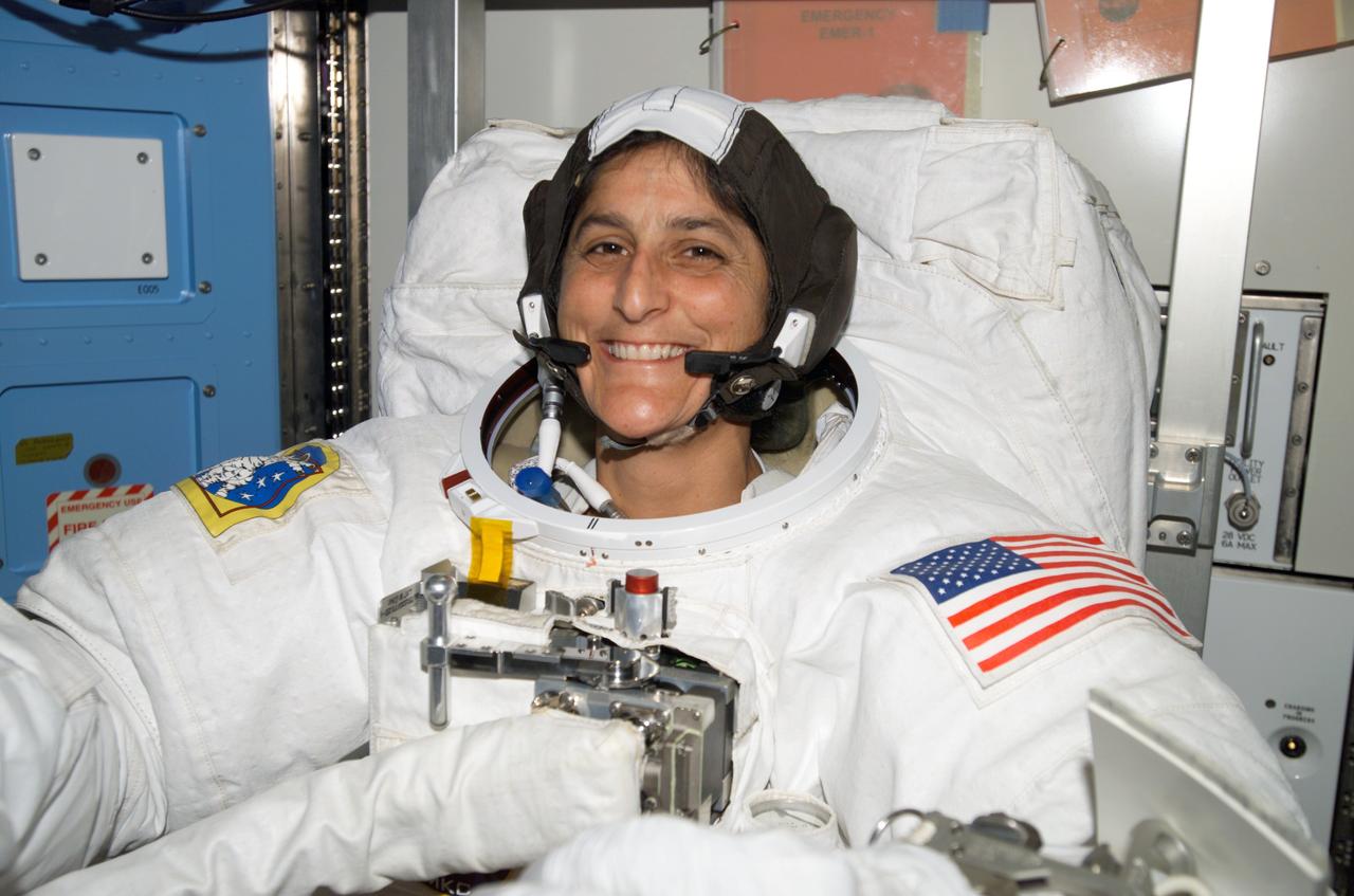 ISS014-E-13538 (8 Feb. 2007) --- Astronaut Sunita L. Williams, Expedition 14 flight engineer, attired in her Extravehicular Mobility Unit (EMU) spacesuit, awaits the start of the third session of extravehicular activity (EVA) in nine days in the Quest Airlock of the International Space Station.