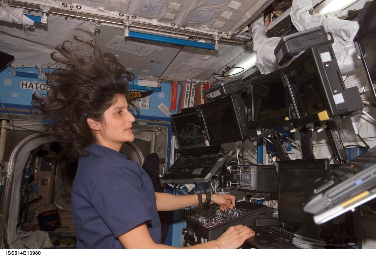 ISS014-E-13980 (19 Feb. 2007) --- Astronaut Sunita L. Williams, Expedition 14 flight engineer, works the controls of the Space Station Remote Manipulator System (SSRMS) or Canadarm2 in the Destiny laboratory of the International Space Station.