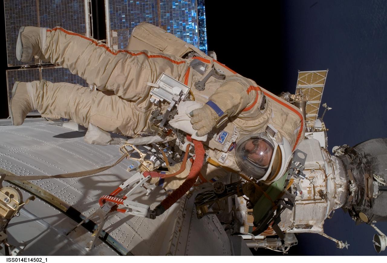 ISS014-E-14502 (22 Feb. 2007) --- Cosmonaut Mikhail Tyurin, Expedition 14 flight engineer representing Russia's Federal Space Agency, wearing a Russian Orlan spacesuit, participates in a session of extravehicular activity (EVA). Among other tasks, Tyurin and astronaut Michael E. Lopez-Alegria (out of frame), commander and NASA space station science officer, were able to retract a stuck Kurs antenna on the Progress vehicle docked to the International Space Station's Zvezda Service Module.