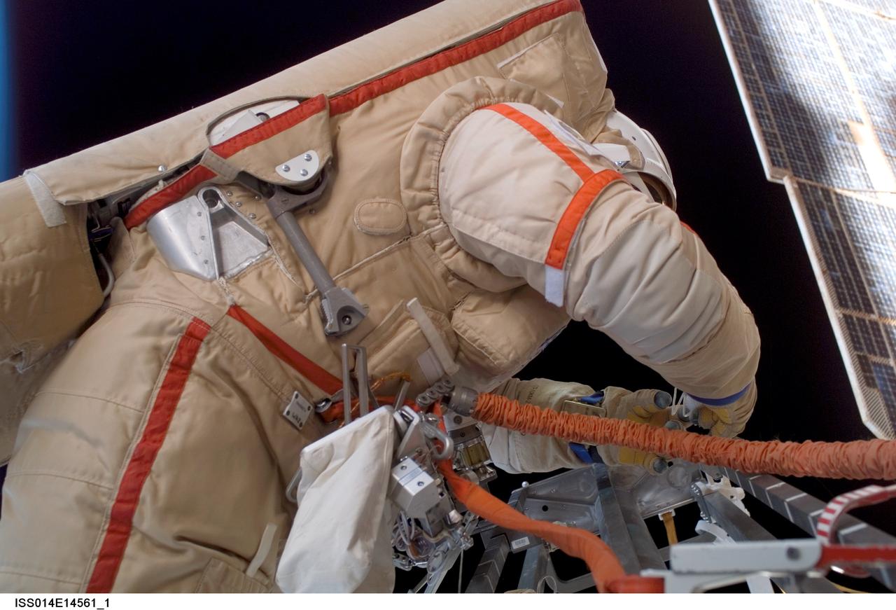 ISS014-E-14561 (22 Feb. 2007) --- Astronaut Michael E. Lopez-Alegria, Expedition 14 commander and NASA space station science officer, wearing a Russian Orlan spacesuit, participates in a session of extravehicular activity (EVA). Among other tasks, Lopez-Alegria and cosmonaut Mikhail Tyurin (out of frame), flight engineer representing Russia's Federal Space Agency, were able to retract a stuck antenna on the Progress vehicle docked to the International Space Station's Zvezda Service Module.