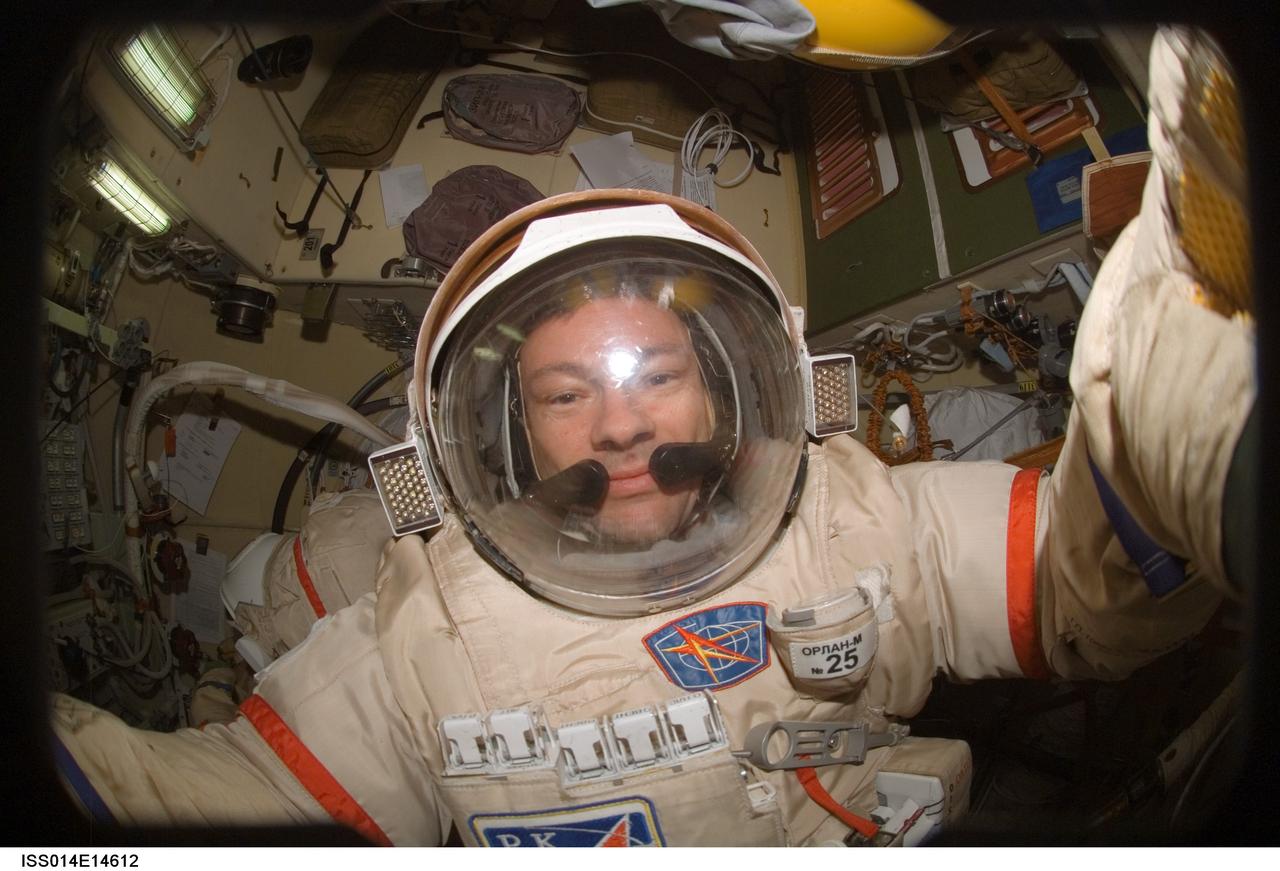 ISS014-E-14612 (20 Feb. 2007) --- Astronaut Michael E. Lopez-Alegria, Expedition 14 commander and NASA space station science officer, performs a Russian Orlan spacesuit fit check in the Pirs Docking Compartment of the International Space Station. The Expedition 14 crewmembers are two days away from their final scheduled spacewalk.