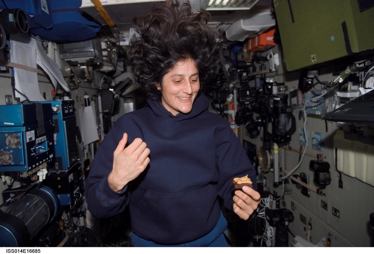 ISS014-E-16685 (12 March 2007) --- Astronaut Sunita L. Williams, Expedition 14 flight engineer, takes a snack break near the galley in the Zvezda Service Module of the International Space Station.