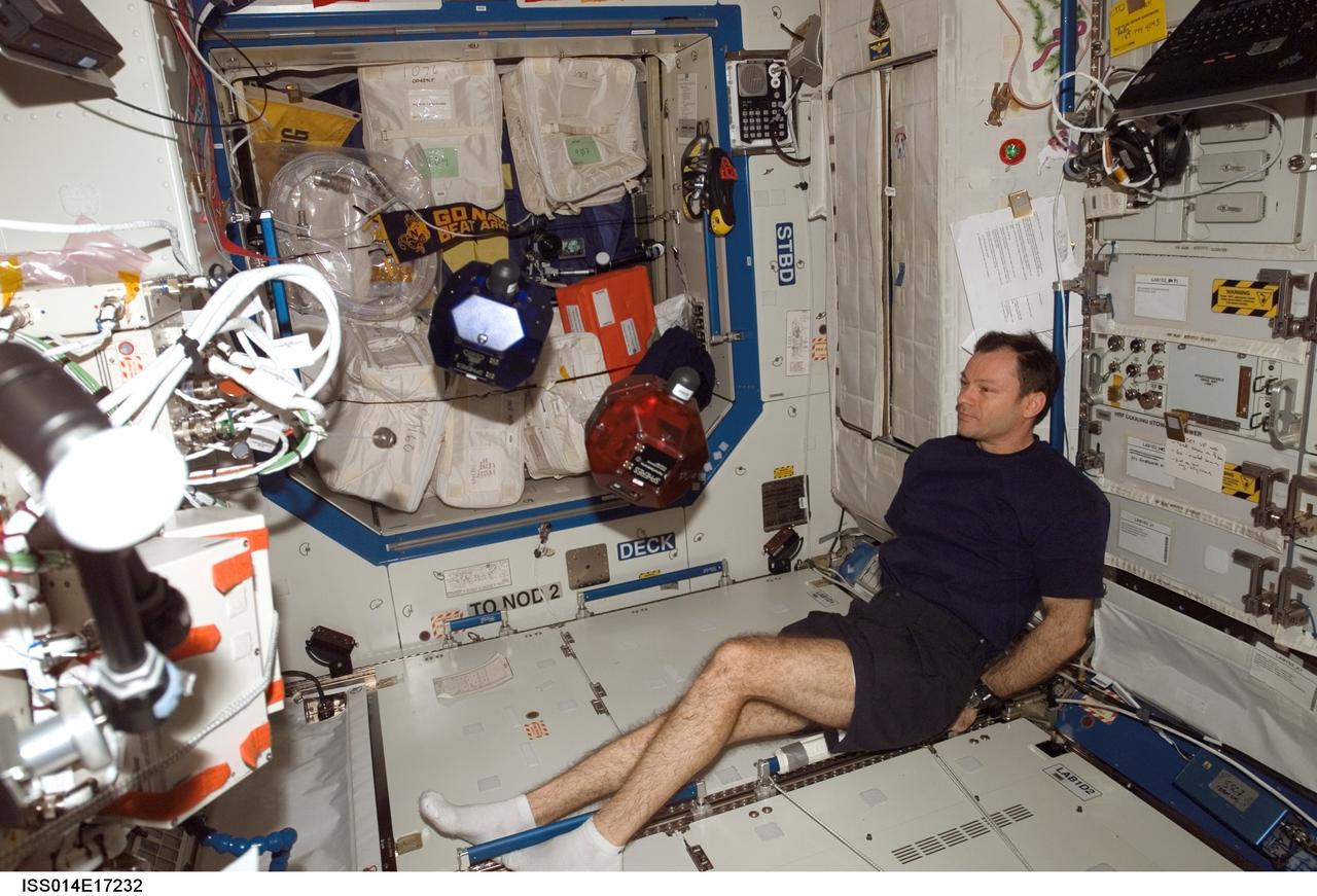 ISS014-E-17232 (17 March 2007) --- Astronaut Michael E. Lopez-Alegria, Expedition 14 commander and NASA space station science officer, does a check of the Synchronized Position Hold, Engage, Reorient, Experimental Satellites (SPHERES) Beacon / Beacon Tester in the Destiny laboratory of the International Space Station.