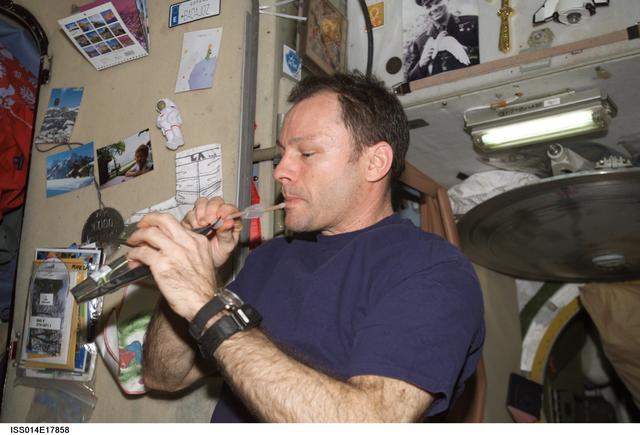 NASA image: Lopez-Alegria with drink packet in Zvezda