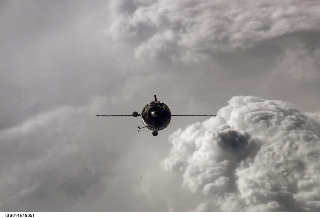 ISS014-E-19051 (9 April 2007) --- Backdropped by a cloud-covered Earth, the Soyuz 14 (TMA-10) spacecraft approaches the International Space Station. Onboard the spacecraft are cosmonauts Fyodor N. Yurchikhin, Expedition 15 commander; and Oleg V. Kotov, Soyuz commander and flight engineer, both representing Russia's Federal Space Agency; along with spaceflight participant Charles Simonyi. With Kotov at the controls, the Soyuz linked up to the Zarya module nadir port at 2:10 p.m. (CDT) on April 9, 2007. The docking followed Saturday's launch from Baikonur Cosmodrome in Kazakhstan.