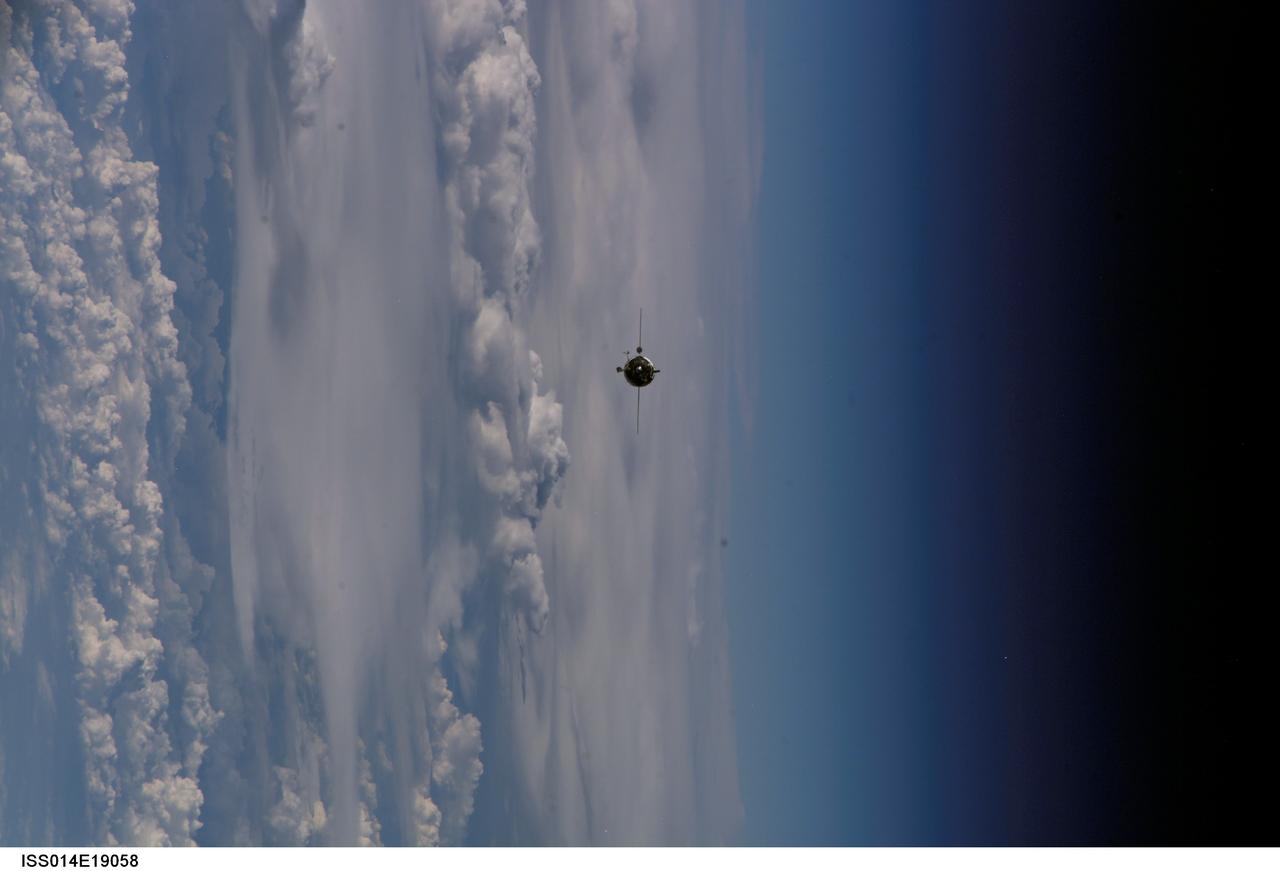 ISS014-E-19058 (9 April 2007) --- Backdropped by a cloud-covered Earth and the blackness of space, the Soyuz 14 (TMA-10) spacecraft approaches the International Space Station. Onboard the spacecraft are cosmonauts Fyodor N. Yurchikhin, Expedition 15 commander; and Oleg V. Kotov, Soyuz commander and flight engineer, both representing Russia's Federal Space Agency; along with spaceflight participant Charles Simonyi. With Kotov at the controls, the Soyuz linked up to the Zarya module nadir port at 2:10 p.m. (CDT) on April 9, 2007. The docking followed Saturday's launch from Baikonur Cosmodrome in Kazakhstan.