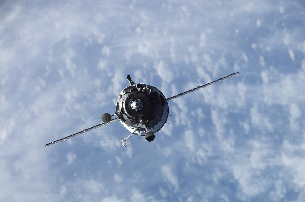 ISS014-E-19086 (9 April 2007) --- Backdropped by a cloud-covered Earth, the Soyuz 14 (TMA-10) spacecraft approaches the International Space Station. Onboard the spacecraft are cosmonauts Fyodor N. Yurchikhin, Expedition 15 commander; and Oleg V. Kotov, Soyuz commander and flight engineer, both representing Russia's Federal Space Agency; along with spaceflight participant Charles Simonyi. With Kotov at the controls, the Soyuz linked up to the Zarya module nadir port at 2:10 p.m. (CDT) on April 9, 2007. The docking followed Saturday's launch from Baikonur Cosmodrome in Kazakhstan.