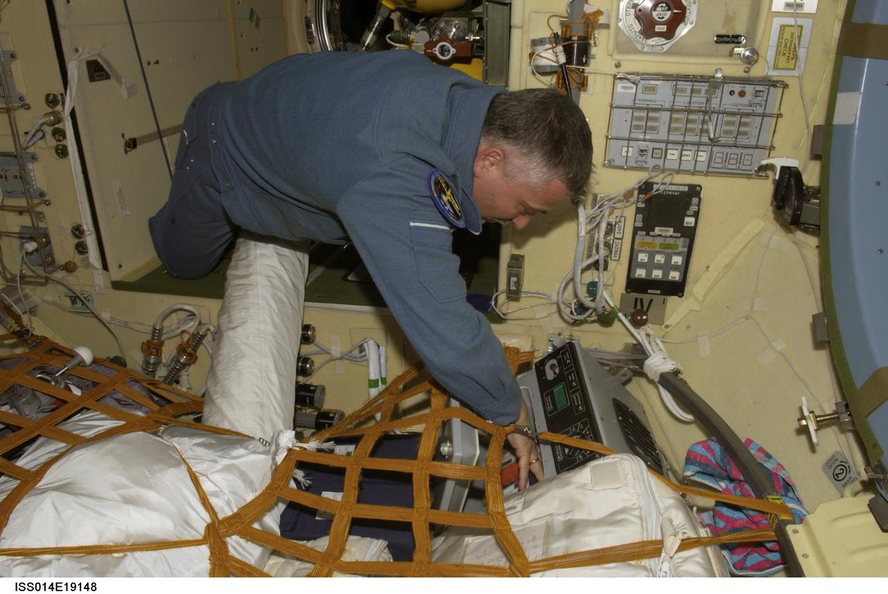 ISS014-E-19148 (April 2007) --- Cosmonaut Fyodor N. Yurchikhin, Expedition 15 commander representing Russia's Federal Space Agency, works with a Cryogem-03 refrigerator in the Zvezda Service Module of the International Space Station.