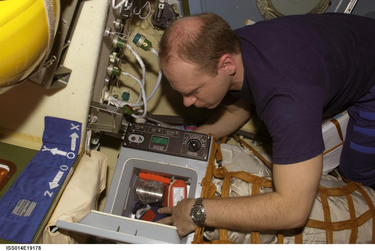 ISS014-E-19178 (April 2007) --- Cosmonaut Oleg V. Kotov, Expedition 15 flight engineer representing Russia's Federal Space Agency, works with a Cryogem-03 refrigerator in the Zvezda Service Module of the International Space Station.