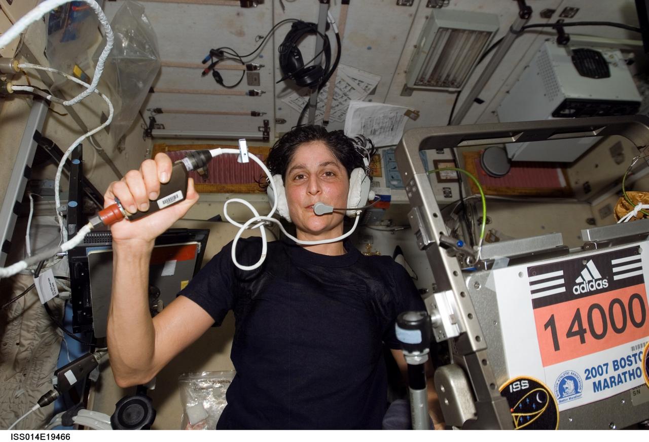 ISS014-E-19466 (16 April 2007) --- Astronaut Sunita L. Williams, Expedition 14 flight engineer, circled Earth almost three times as she participated in the Boston Marathon from space. She is seen here with her feet off the station treadmill on which she ultimately ran about six miles per hour while flying more than five miles each second. The treadmill is called TVIS, for Treadmill Vibration Isolation System, by the crewmembers and their ground support team.  Williams' official completion time was four hours, 23 minutes and 10 seconds as she completed the race at 2:24 p.m. (EDT).