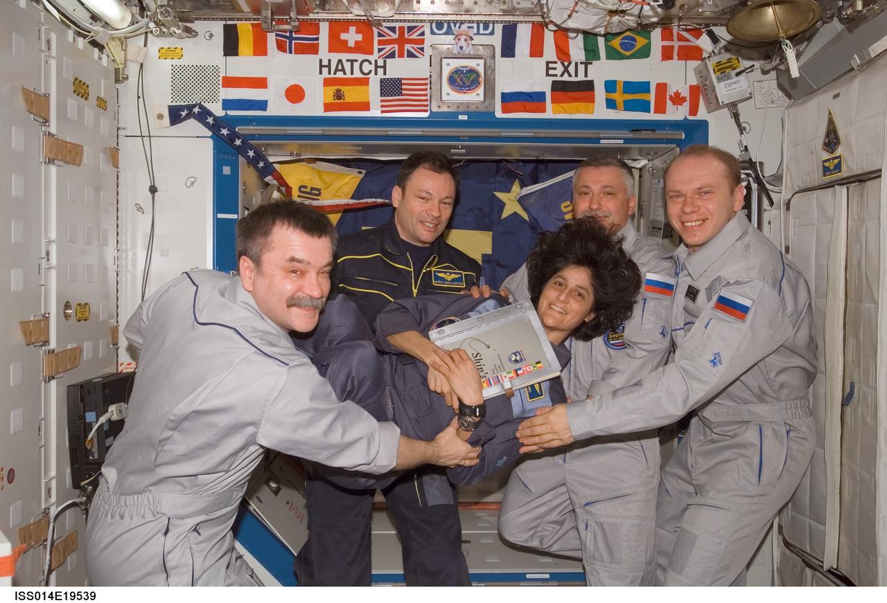 ISS014-E-19539 (17 April 2007) --- The crewmembers onboard the International Space Station enjoy a light moment as they pose for a group portrait during the ceremony of Changing-of-Command from Expedition 14 to Expedition 15 in the Destiny laboratory. From the left are cosmonaut Mikhail Tyurin, Expedition 14 flight engineer; astronaut Michael E. Lopez-Alegria, Expedition 14 commander and NASA space station science officer; astronaut Sunita L. Williams, Expedition 14/15 flight engineer; cosmonauts Fyodor N. Yurchikhin, Expedition 15 commander; and Oleg V. Kotov, Expedition 15 flight engineer. Tyurin, Yurchikhin and Kotov represent Russia's Federal Space Agency.