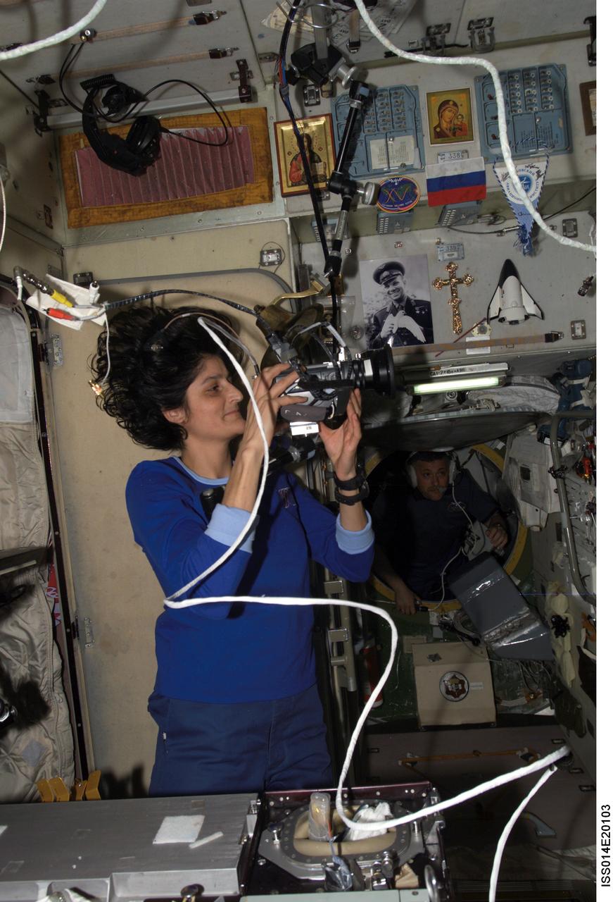 ISS014-E-20103 (21 April 2007) --- Astronaut Sunita L. Williams, Expedition 14/15 flight engineer, sets up a video camera in the Zvezda Service Module of the International Space Station.