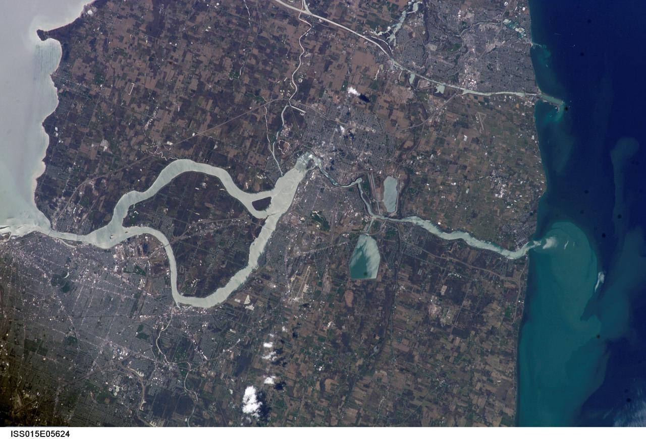 ISS015-E-05624 (29 April 2007) --- The Niagara River, eastern end of Lake Erie and western end of Lake Ontario are featured in this image photographed by an Expedition 15 crewmember on the International Space Station. In contrast, an image photographed by an Expedition 14 crewmember just a month earlier on March 21, 2007 (ISS014-E-17999) shows Lake Erie clogged with ice that is pushed against the shore line by the prevailing weather systems from the west. These two images document the breakup of the Lake Erie ice pack, the unofficial signature of spring for residents of Buffalo and Niagara Falls. During the winter months, the ice collects in Lake Erie and is prevented from flowing down the Niagara River (the international boundary between Ontario, Canada and New York State) by the Lake Erie-Niagara River Ice Boom. The 2,680-meter (8,800-foot) boom, administered by the 1909 Boundary Water Treaty's International Niagara Board of Control, is deployed each December. Operational since 1964, the boom serves several functions: it protects the water intakes for the Niagara River power plants, and minimizes ice runs and ice blockages that can create damage and flooding along the river. At the height of winter, the thickness of the ice at the Buffalo harbor can reach 3.5 meters (12 feet). The removal of the ice boom, usually in early April, is now marked by local celebrations. This year the boom was removed in mid-April, a bit later than usual.