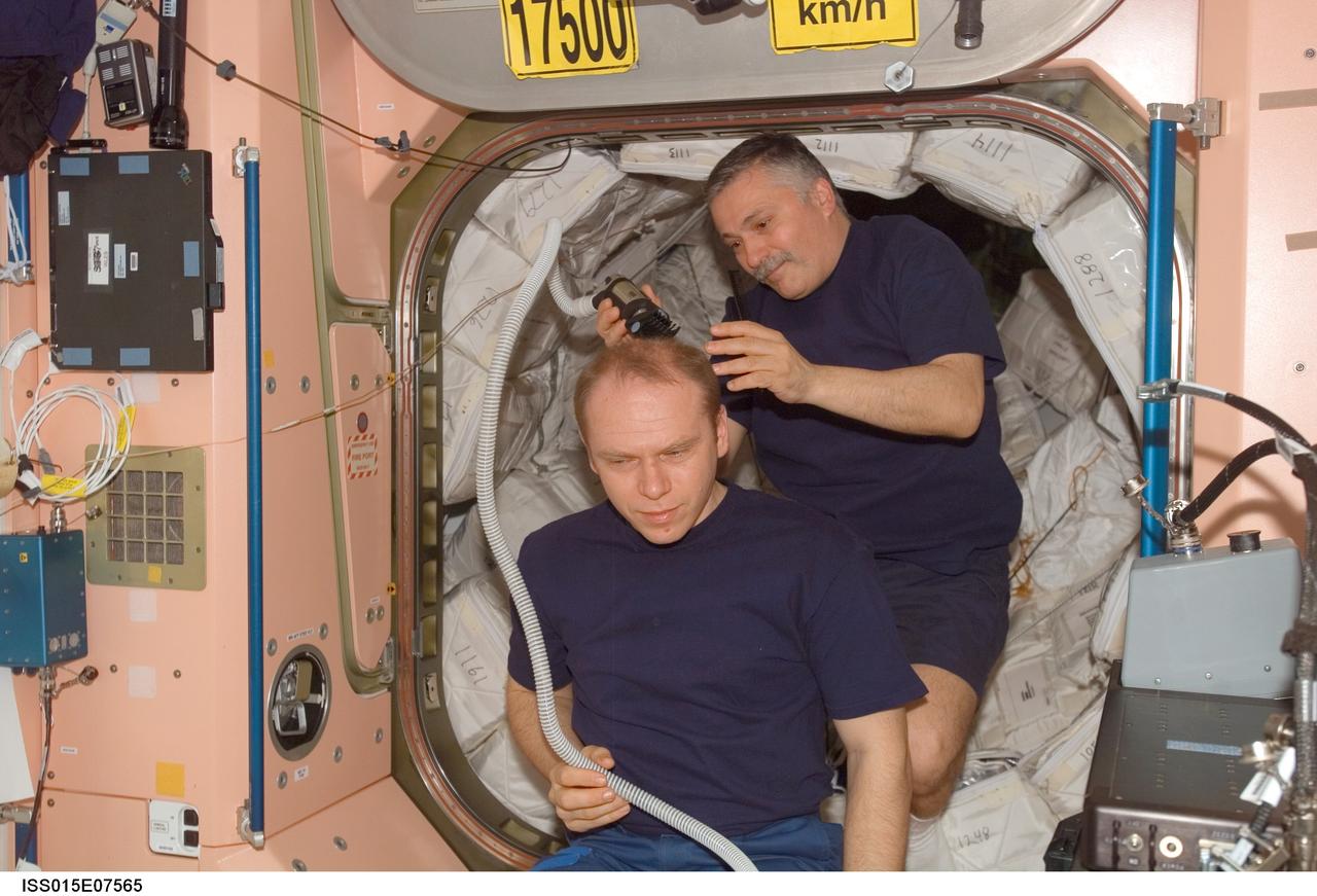 ISS015-E-07565 (13 May 2007) --- Cosmonaut Fyodor N. Yurchikhin, Expedition 15 commander, trims cosmonaut Oleg V. Kotov's hair in the Unity node of the International Space Station. Yurchikhin used hair clippers fashioned with a vacuum device to garner freshly cut hair. Kotov, flight engineer, and Yurchikhin represent Russia's Federal Space Agency.