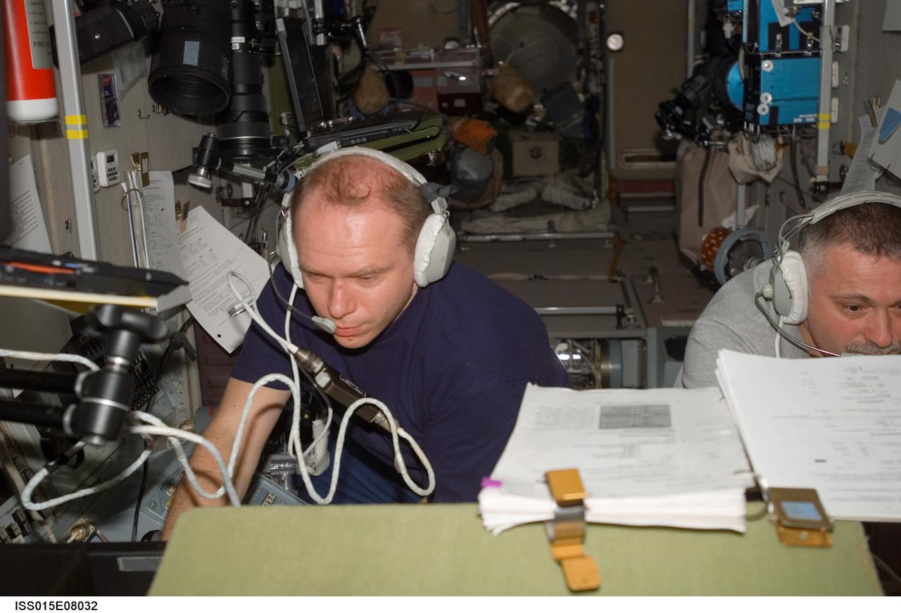 ISS015-E-08032 (15 May 2007) --- Cosmonauts Fyodor N. Yurchikhin (right) and Oleg V. Kotov, Expedition 15 commander and flight engineer, respectively, representing Russia's Federal Space Agency, use communication systems in the Zvezda Service Module of the International Space Station during docking operations of the Progress 25 resupply craft.