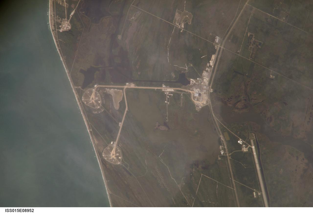 ISS015-E-08952 (21 May 2007) --- An 800-mm lens look from the International Space Station shows the Kennedy Space Center around midday on May 21, 2007. Astronaut Sunita L. Williams, Expedition 15 flight engineer, took the photo. The Space Shuttle Atlantis, scheduled for a launch no earlier than June 8, sits on Pad A (center left) at launch complex 39. Pad B can be seen near bottom. The giant Vehicle Assembly Building (right center) and part of the Shuttle Landing Facility (lower right) are among other facilities seen in the digital frame.