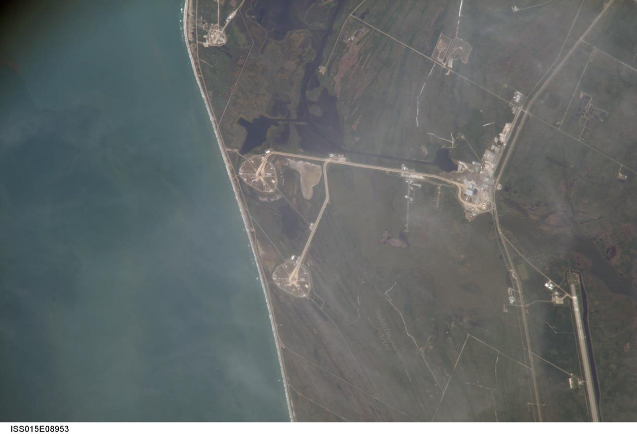 ISS015-E-08953 (21 May 2007) --- An 800-mm lens look from the International Space Station shows the Kennedy Space Center around midday on May 21, 2007.  Astronaut Sunita L. Williams, Expedition 15 flight engineer, took the photo. The Space Shuttle Atlantis, scheduled for a launch no earlier than June 8, sits on Pad A (center frame) at launch complex 39. Pad B can be seen near bottom. The giant Vehicle Assembly Building (right center) and part of the Shuttle Landing Facility (lower right edge) are among other facilities seen in the digital frame