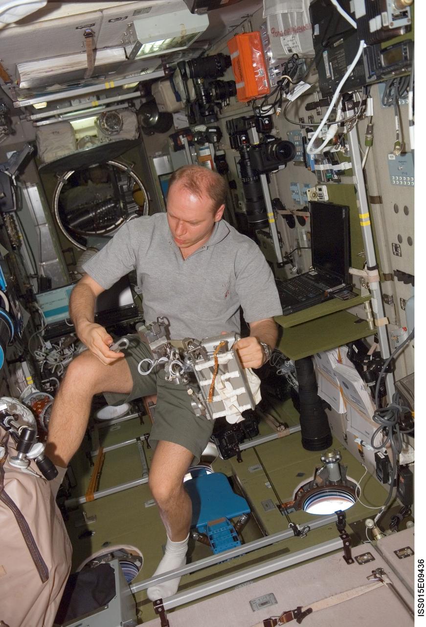 ISS015-E-09436 (24 May 2007) --- Cosmonaut Oleg V. Kotov, Expedition 15 flight engineer representing Russia's Federal Space Agency, works with an Orlan Tether Adapter assembly in the Zvezda Service Module of the International Space Station.