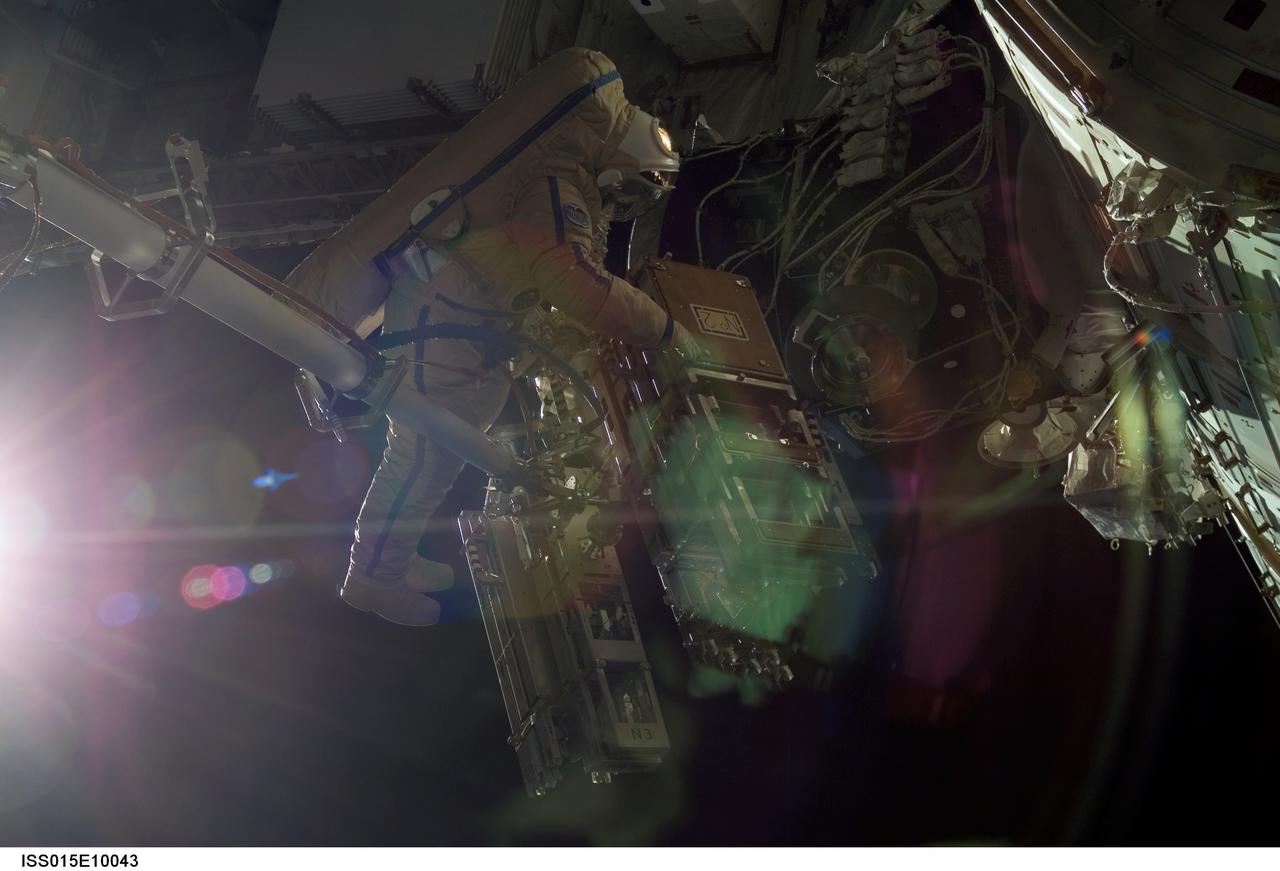 ISS015-E-10043 (30 May 2007) --- Cosmonaut Oleg V. Kotov, Expedition 15 flight engineer representing Russia's Federal Space Agency, wearing a Russian Orlan spacesuit, participates in a session of extravehicular activity (EVA). Among other tasks, Kotov and cosmonaut Fyodor N. Yurchikhin (out of frame), commander representing Russia's Federal Space Agency, retrieved the "Christmas tree" bundle of three packages of 17 protective debris panels for installation around the forward cone of the Zvezda Service Module of the International Space Station and to install the first set of those panels. The aluminum debris protection panels are designed to shield the module from micro-meteoroids.