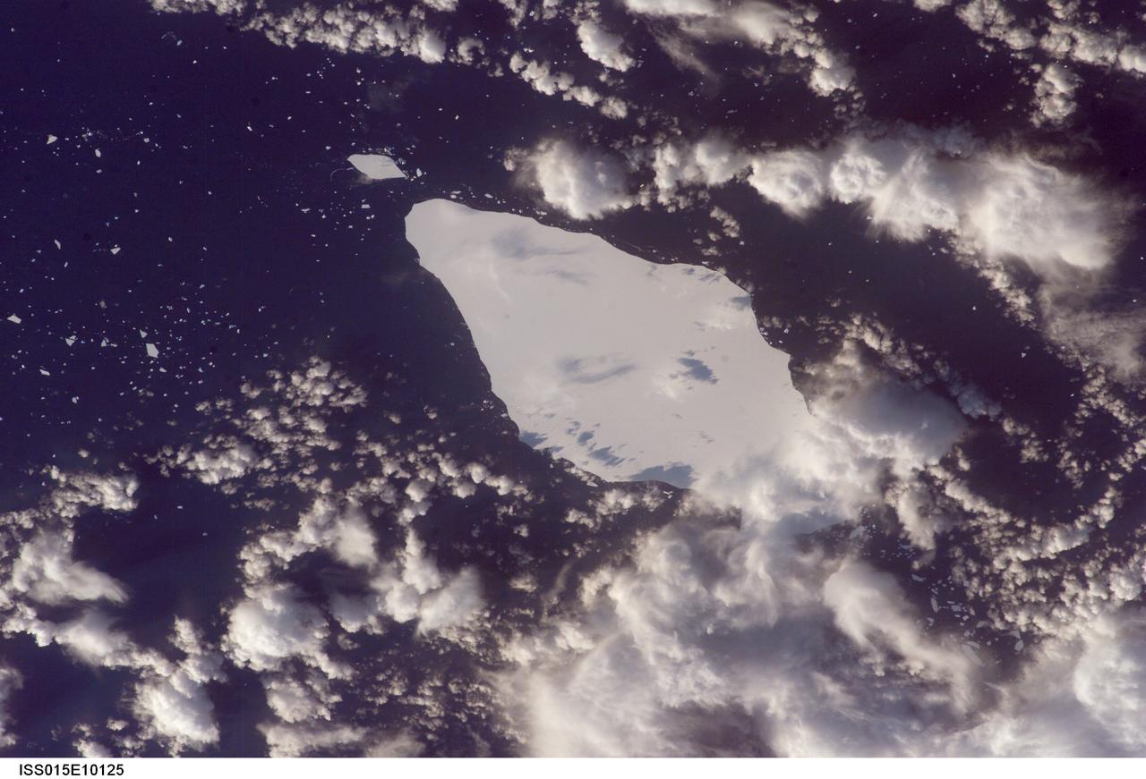 ISS015-E-10125 (30 May 2007) --- An iceberg in the South Atlantic Ocean is featured in this image photographed by an Expedition 15 crewmember on the International Space Station. This iceberg illustrates the remains of a giant iceberg -- designated A22A that broke off Antarctica in 2002. This is one of the largest icebergs to drift as far north as 50 degrees south latitude, bringing it beneath the daylight path of the station. Crewmembers aboard the orbital complex were able to locate the ice mass and photograph it, despite great cloud masses of winter storms in the Southern Ocean.  Dimensions of A22A in early June were 49.9 x 23.4 kilometers, giving it an area of 622 square kilometers, or seven times the area of Manhattan Island.
