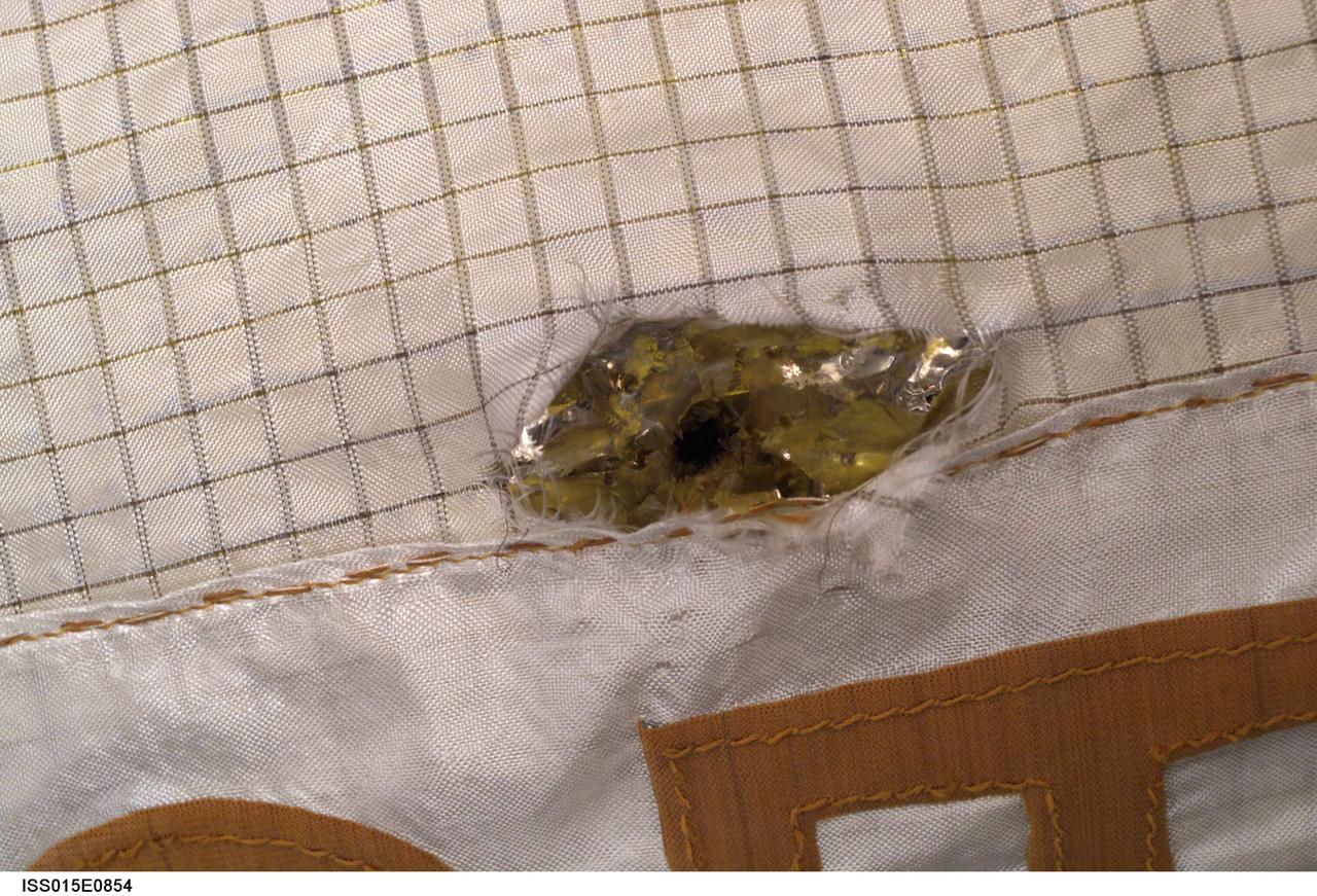 ISS015-E-10854 (6 June 2007) --- During the Russian spacewalk conducted by cosmonauts Fyodor Yurchikhin, Expedition 15 commander, and Oleg Kotov, flight engineer, on June 6, 2007, Yurchikhin commented on damage to a multi-layer insulation (MLI) protective blanket on the Zarya module. The damage, he noted, was apparently from a micrometeoroid impact. The date the damage occurred is unknown but has had no impact to vehicle operations.