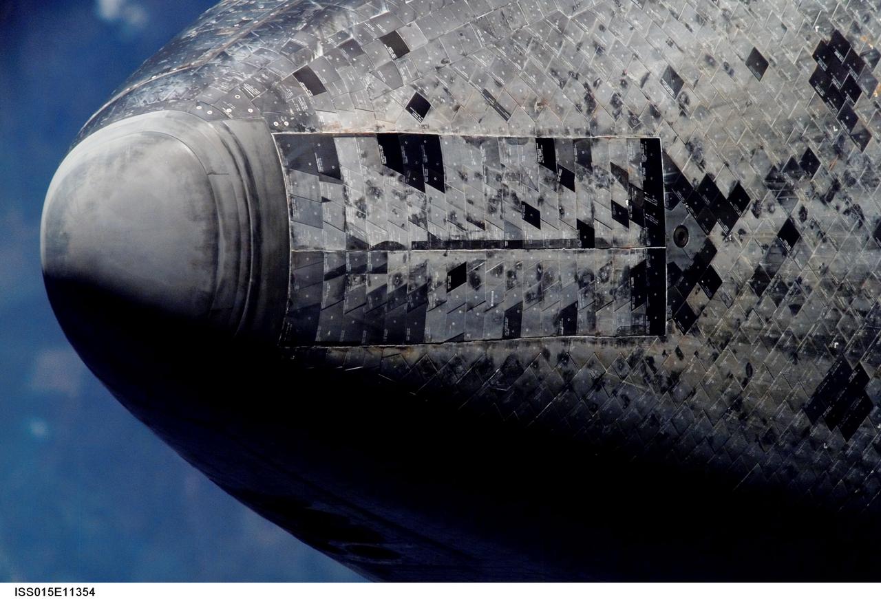 ISS015-E-11354 (10 June 2007) --- This is one of a series of images photographed with a digital still camera using an 800mm focal length featuring the different areas of the Space Shuttle Atlantis as it approached the International Space Station and performed a back-flip to accommodate close scrutiny by eyeballs and cameras. This image shows a view of the underside of nose/nosecap and forward landing gear doors. Distance from the station and shuttle at this time was approximately 600 feet.