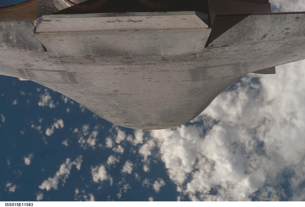 ISS015-E-11583 (10 June 2007) --- This view of the underside of Space Shuttle Atlantis was provided by an Expedition 15 crewmember during a back-flip for the RPM survey by the approaching STS-117 crew to the International Space Station. Distance from the station and shuttle at this time was approximately 600 feet.