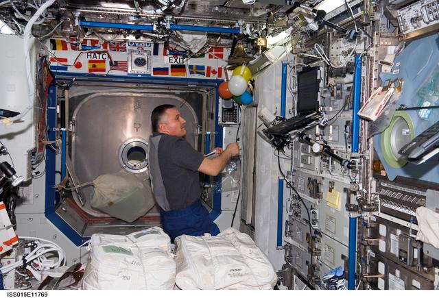 NASA image: View of Yurchikhin preparing for the STS-117 Hatch Opening during Expedition 15