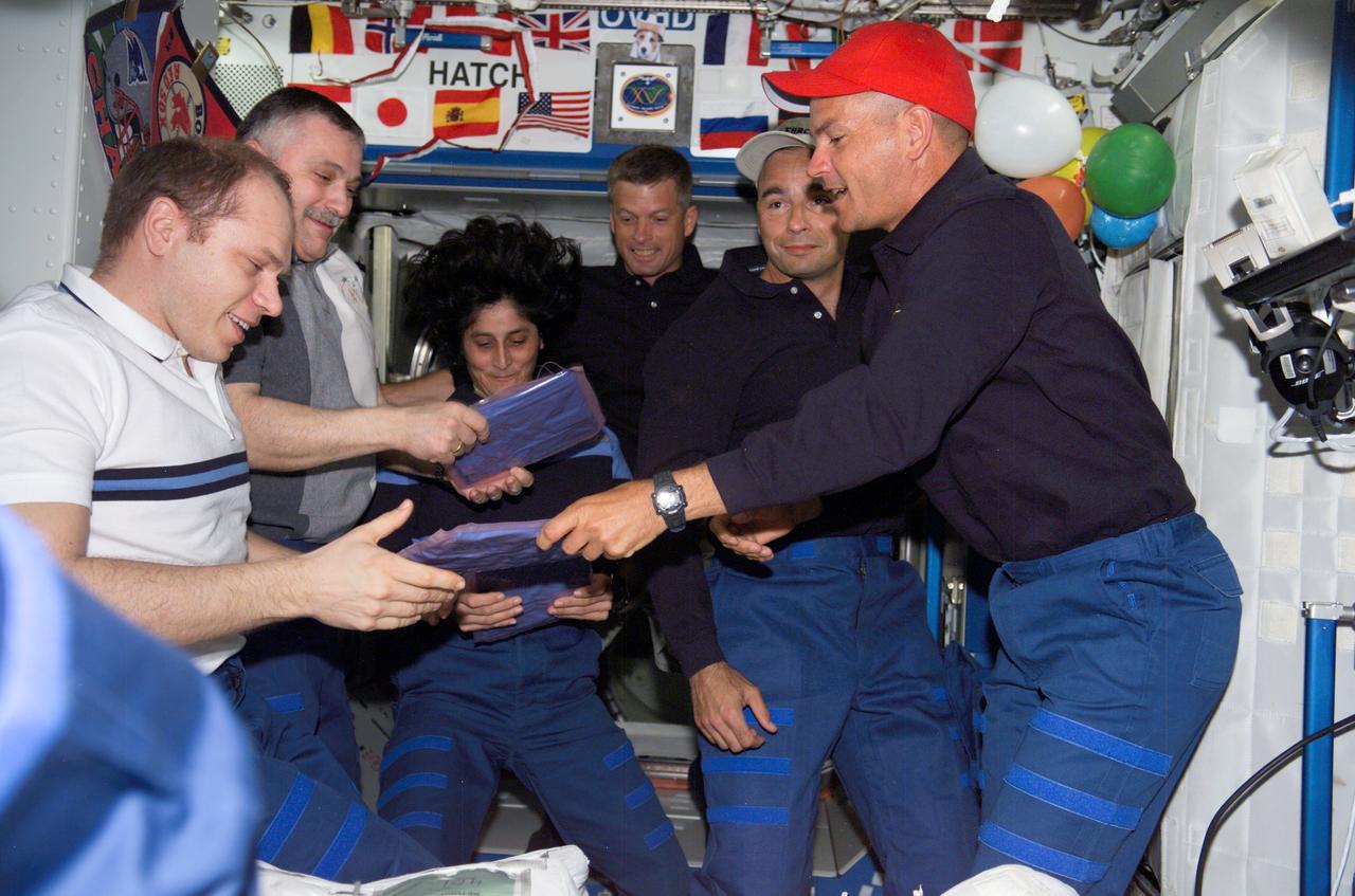 ISS015-E-11778 (10 June 2007) --- The STS-117 crewmembers give the Expedition 15 crewmembers packages from Earth in the Destiny laboratory of the International Space Station shortly after Space Shuttle Atlantis docked with the station. Pictured are (left to right) cosmonauts Oleg V. Kotov and Fyodor N. Yurchikhin, Expedition 15 flight engineer and commander, respectively, representing Russia's Federal Space Agency; astronauts Sunita L. Williams, Expedition 15 flight engineer; Steven Swanson, STS-117 mission specialist; Lee Archambault, STS-117 pilot; and Rick Sturckow, STS-117 commander.