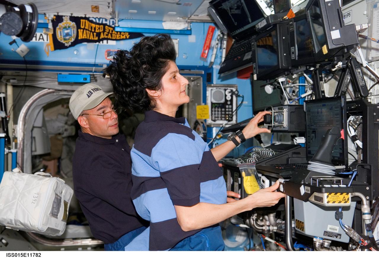 ISS015-E-11782 (10 June 2007) --- Astronauts Sunita L. Williams (foreground), Expedition 15 flight engineer, and Lee Archambault, STS-117 pilot, work the controls of the Space Station Remote Manipulator System (SSRMS) or Canadarm2 in the Destiny laboratory of the International Space Station during STS-117 flight day three activities.