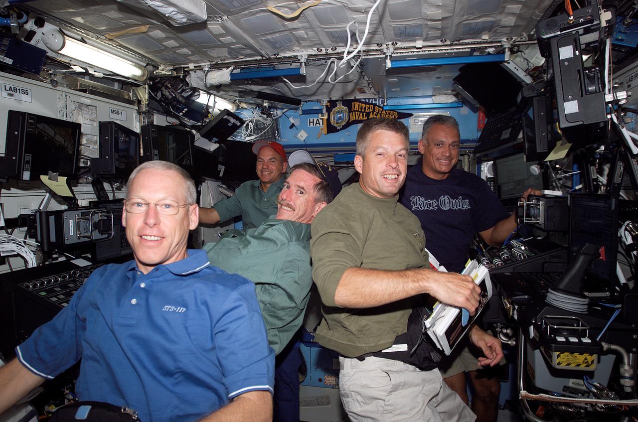 ISS015-E-11959 (12 June 2007) --- STS-117 crewmembers take a moment to pose for a photo while working various tasks in the Destiny laboratory of the International Space Station during flight day five activities while Space Shuttle Atlantis was docked with the station. Pictured at left are astronauts Patrick Forrester (foreground), Jim Reilly, both mission specialists; and Rick Sturckow, commander. On the right are astronauts Steven Swanson (foreground) and John "Danny" Olivas, both mission specialists.