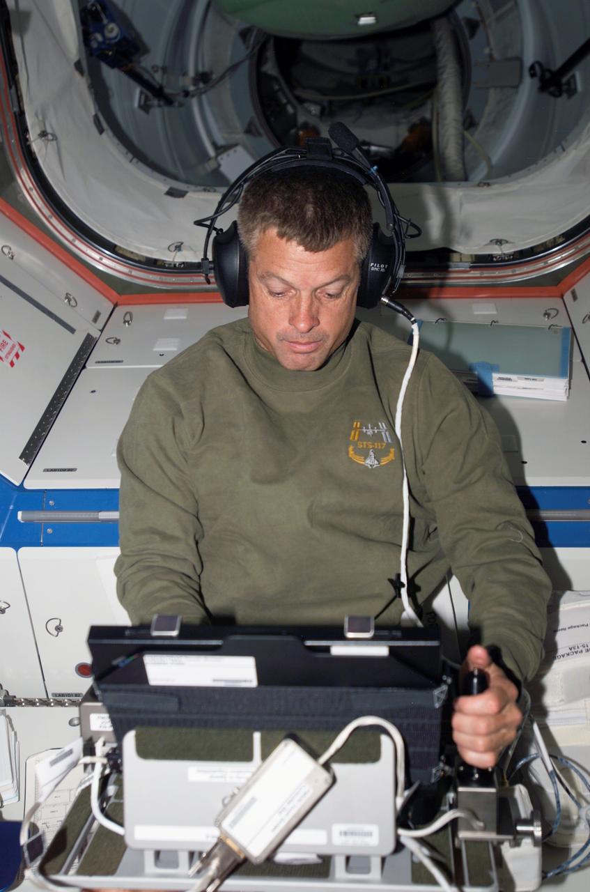 ISS015-E-11968 (12 June 2007) --- Astronaut Steven Swanson, STS-117 mission specialist, works with the Perceptual Motor Deficits in Space (PMDIS) experiment in the Destiny laboratory of the International Space Station. The PMDIS experiment will measure the decline in hand-eye coordination of shuttle astronauts while on orbit. These measurements will be used to evaluate various mechanisms thought to be responsible for the decline.