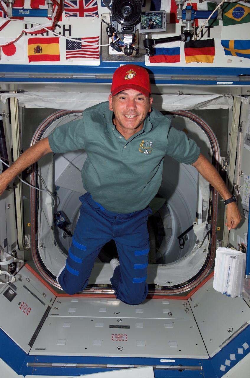 ISS015-E-11970 (12 June 2007) --- Astronaut Rick Sturckow, STS-117 commander, poses for a photo in the Destiny laboratory of the International Space Station during flight day five activities while Space Shuttle Atlantis was docked with the station.