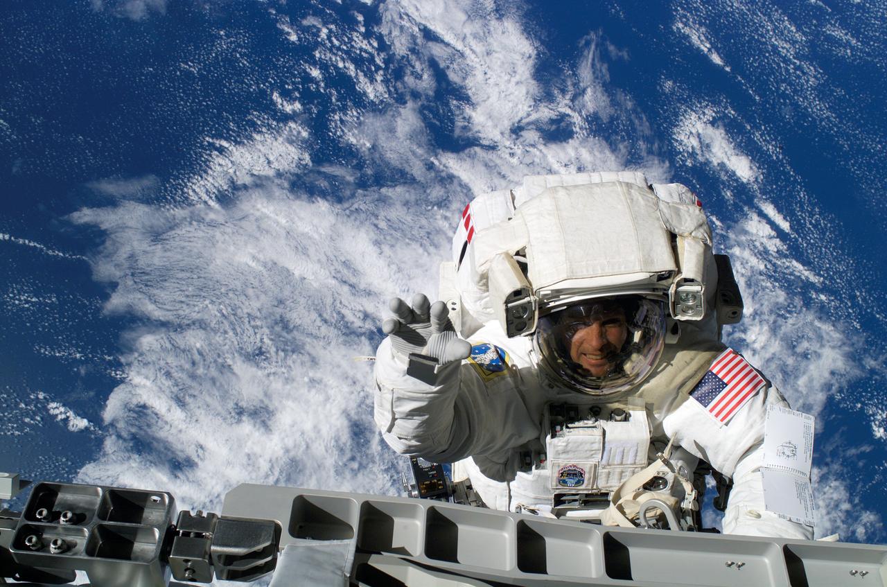 ISS015-E-12063 (13 June 2007) --- Astronauts Steven Swanson and Patrick Forrester (out of frame), both STS-117 mission specialists, participate in the mission's second planned session of extravehicular activity (EVA), as construction resumes on the International Space Station. Among other tasks, Forrester and Swanson removed all of the launch locks holding the 10-foot-wide solar alpha rotary joint in place and began the solar array retraction.