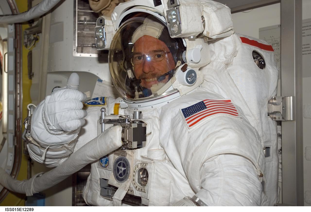 ISS015-E-12289 (15 June 2007) --- Attired in his Extravehicular Mobility Unit (EMU) spacesuit, astronaut Jim Reilly, STS-117 mission specialist, gives a "thumbs-up" signal as he awaits the start of the mission's third session of extravehicular activity (EVA) in the Quest Airlock of the International Space Station while Space Shuttle Atlantis was docked with the station.