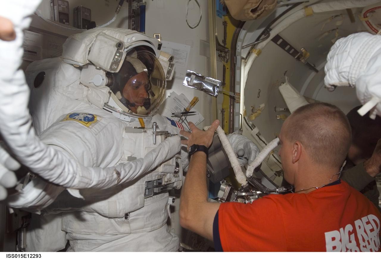 ISS015-E-12293 (15 June 2007) --- Attired in his Extravehicular Mobility Unit (EMU) spacesuit, astronaut John "Danny" Olivas, STS-117 mission specialist, prepares for the mission's third session of extravehicular activity (EVA) in the Quest Airlock of the International Space Station while Space Shuttle Atlantis was docked with the station. Astronaut Clayton Anderson, Expedition 15 flight engineer, assisted Olivas.