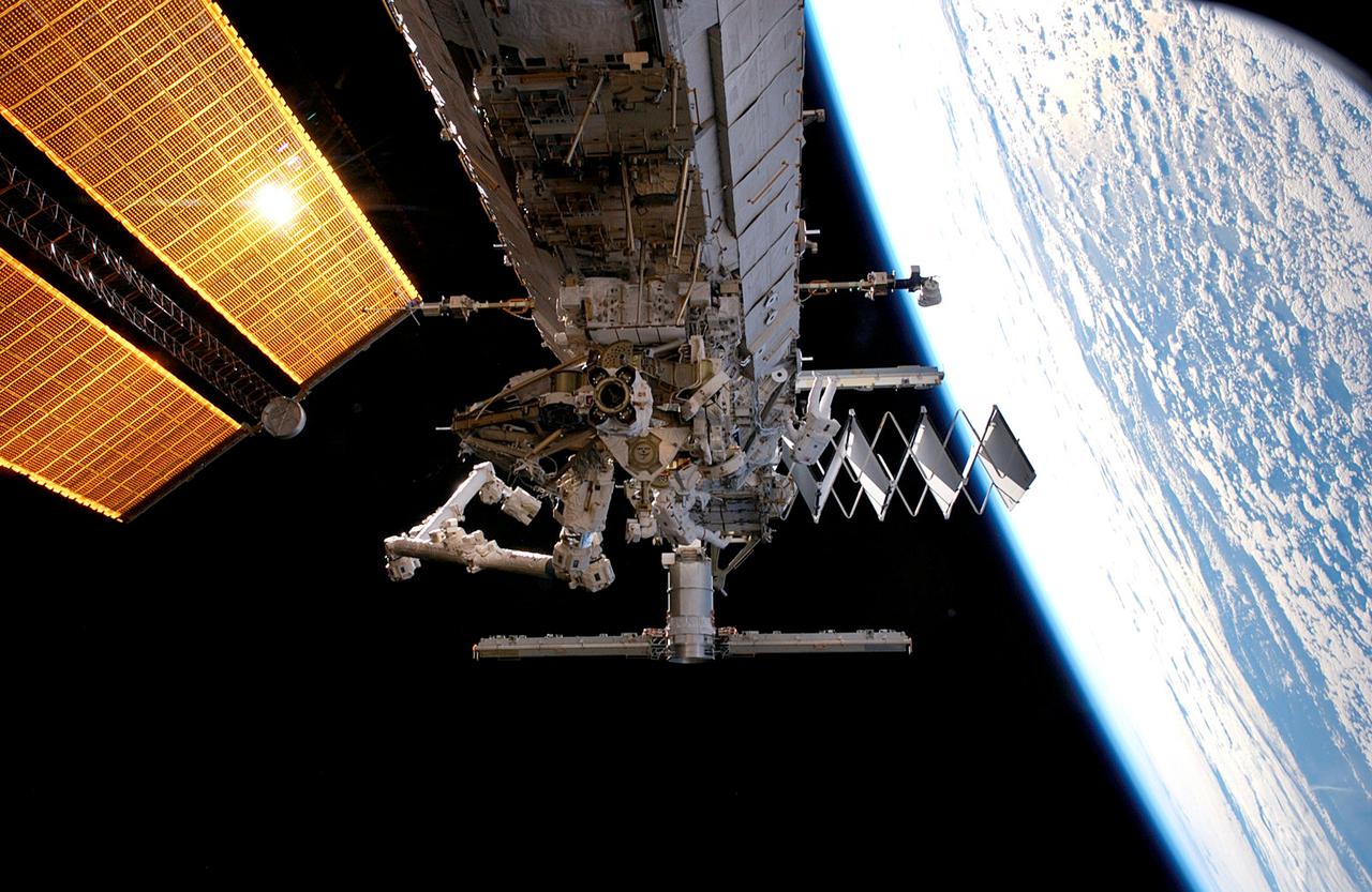 ISS015-E-12863 (11 June 2007) --- Astronauts Jim Reilly (left) and John "Danny" Olivas, both STS-117 mission specialists, participate in the mission's first planned session of extravehicular activity (EVA), as construction continues on the International Space Station. Among other tasks, Reilly and Olivas connected power, data and cooling cables between S1 and S3; released the launch restraints from and deployed the four solar array blanket boxes on S4 and released the cinches and winches holding the photovoltaic radiator on S4. Earth's horizon and the blackness of space provide the backdrop for the scene.