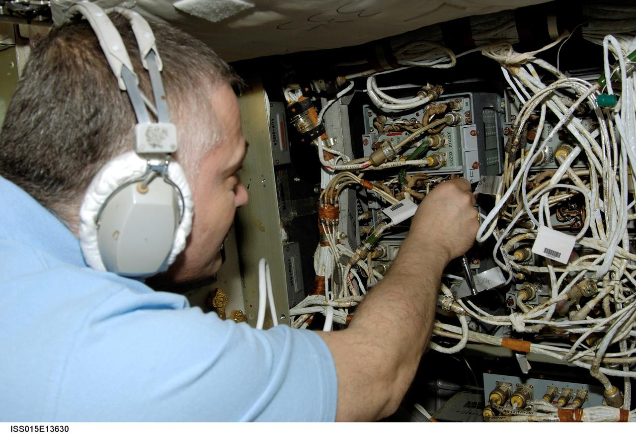 ISS015-E-13630 (25 June 2007) --- Cosmonaut Fyodor N. Yurchikhin, Expedition 15 commander representing Russia's Federal Space Agency, wears communication headgear as he performs in-flight maintenance (IFM) on telemetry hardware in the Zvezda Service Module of the International Space Station.