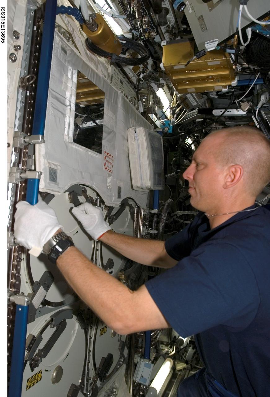 ISS015-E-13695 (25 June 2007) --- Astronaut Clayton Anderson, Expedition 15 flight engineer, works with the Minus Eighty Degree Laboratory Freezer for ISS (MELFI) as part of the Nutritional Status Assessment (NUTRITION) experiment in the Destiny laboratory of the International Space Station. MELFI is a low temperature freezer facility with nominal operating temperatures of -80, -26 and +4 degrees Celsius that will preserve experiment materials over long periods. The results of the Nutrition experiment will be used to better understand the time course effects of space flight on human physiology.