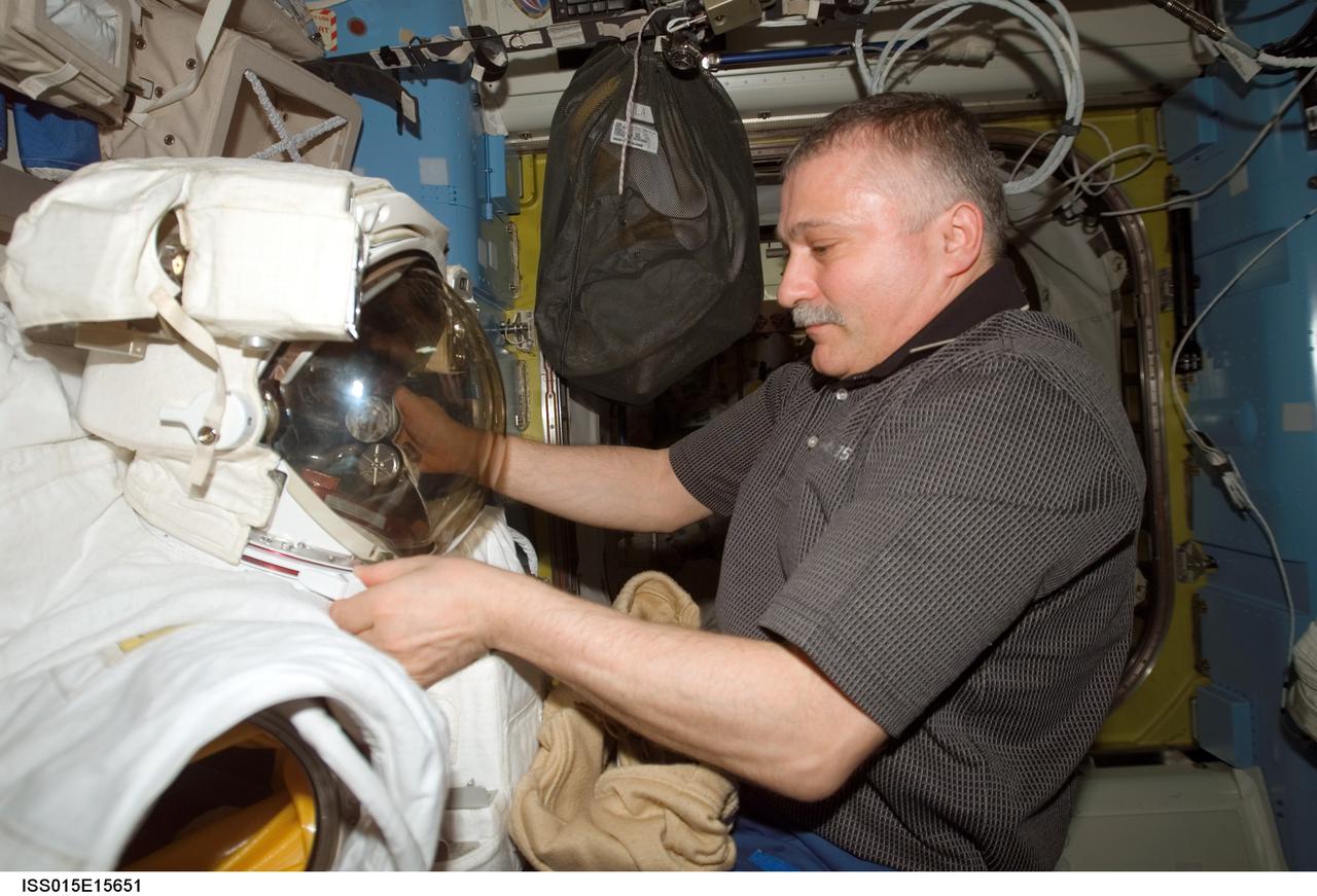 ISS015-E-15651 (2 July 2007) --- Cosmonaut Fyodor N. Yurchikhin, Expedition 15 commander representing Russia's Federal Space Agency, works with an Extravehicular Mobility Unit (EMU) spacesuit in the Quest Airlock of the International Space Station.