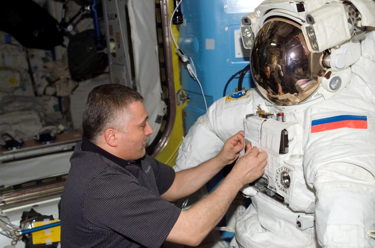 ISS015-E-15670 (2 July 2007) --- Cosmonaut Fyodor N. Yurchikhin, Expedition 15 commander representing Russia's Federal Space Agency, works with an Extravehicular Mobility Unit (EMU) spacesuit in the Quest Airlock of the International Space Station.