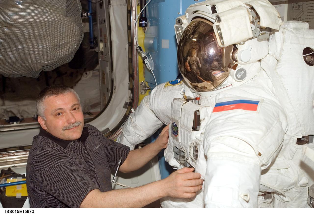 ISS015-E-15673 (2 July 2007) --- Cosmonaut Fyodor N. Yurchikhin, Expedition 15 commander representing Russia's Federal Space Agency, works with an Extravehicular Mobility Unit (EMU) spacesuit in the Quest Airlock of the International Space Station.