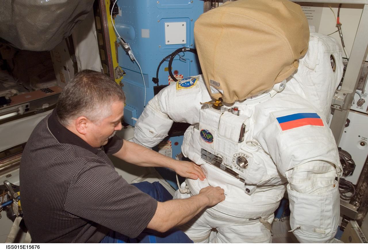 ISS015-E-15676 (2 July 2007) --- Cosmonaut Fyodor N. Yurchikhin, Expedition 15 commander representing Russia's Federal Space Agency, works with an Extravehicular Mobility Unit (EMU) spacesuit in the Quest Airlock of the International Space Station.