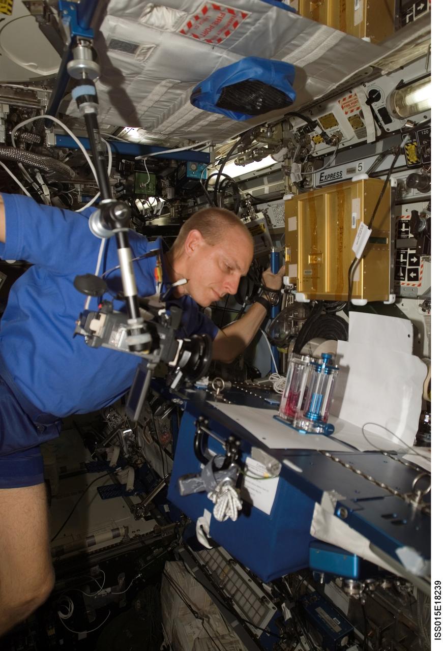 ISS015-E-18239 (14 July 2007) --- Astronaut Clay Anderson, Expedition 15 flight engineer, prepares the Capillary Flow Experiment (CFE) Vane Gap-1 for video documentation. The CFE is positioned on the Maintenance Work Area in the Destiny laboratory of the International Space Station. CFE observes the flow of fluid, in particular capillary phenomena, in microgravity.