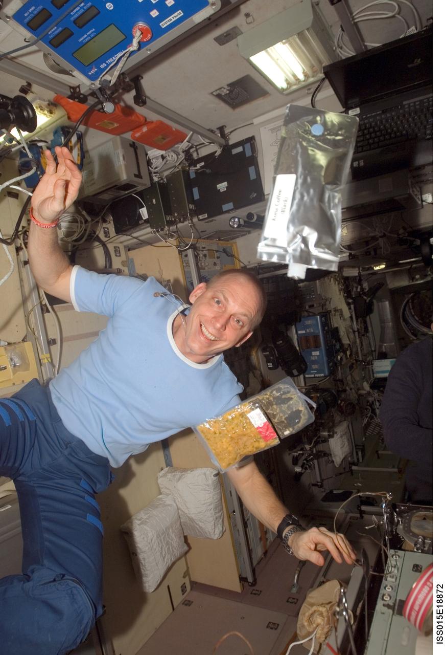 ISS015-E-18872 (21 July 2007) --- Astronaut Clay Anderson, Expedition 15 flight engineer, poses for a photo with food packets floating freely in the Zvezda Service Module of the International Space Station.