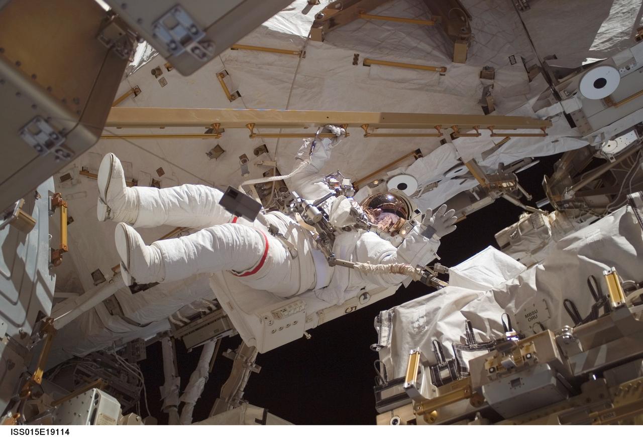 ISS015-E-19114 (23 July 2007) --- Astronaut Clay Anderson, Expedition 15 flight engineer, waves to the camera while participating in a session of extravehicular activity (EVA) as construction continues on the International Space Station. During the 7-hour 41-minute spacewalk, Anderson and cosmonaut Fyodor N. Yurchikhin (out of frame), commander representing Russia's Federal Space Agency, installed a television camera stanchion, reconfigured a power supply for an antenna assembly, and performed several get-ahead tasks. Also, while riding on the end of the Canadarm2, Anderson jettisoned the Early Ammonia Servicer (EAS) by shoving it opposite of the station's direction of travel.