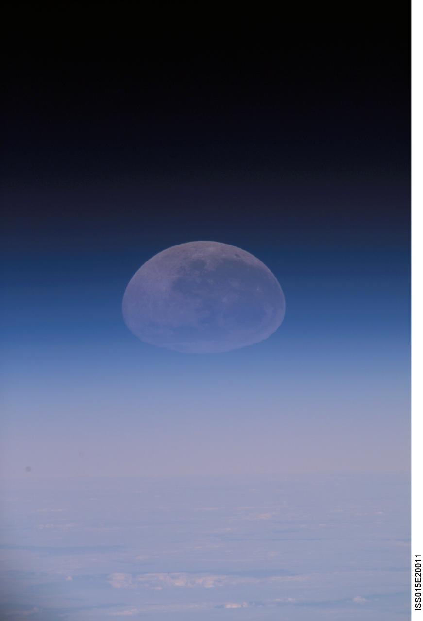 ISS015-E-20011 (30 July 2007) --- A distorted view of a full moon intersecting Earth's horizon is featured in this image photographed by an Expedition 15 crewmember on the International Space Station.